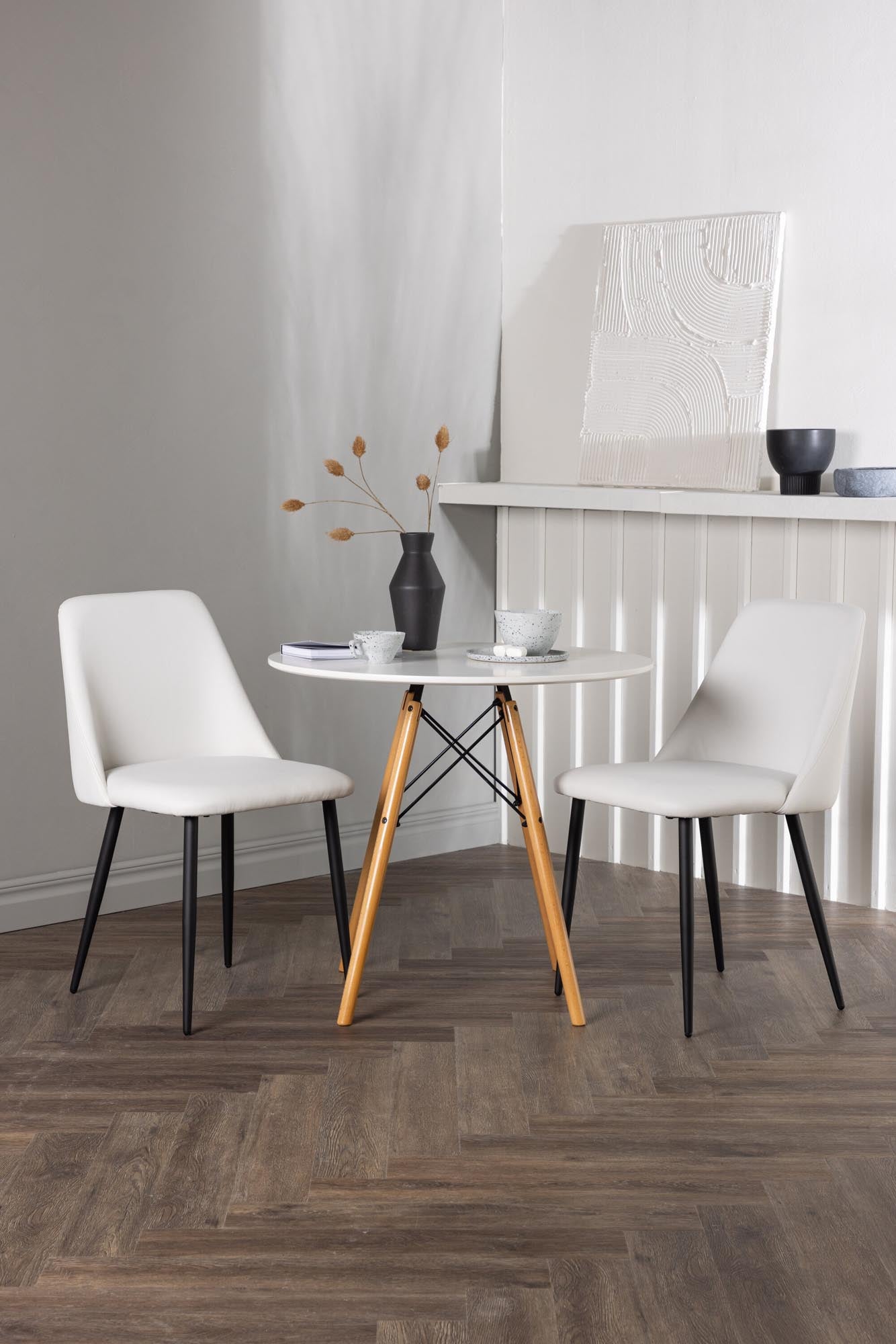 Modernes Danburi Esszimmerset mit rundem Tisch und Samtstühlen.