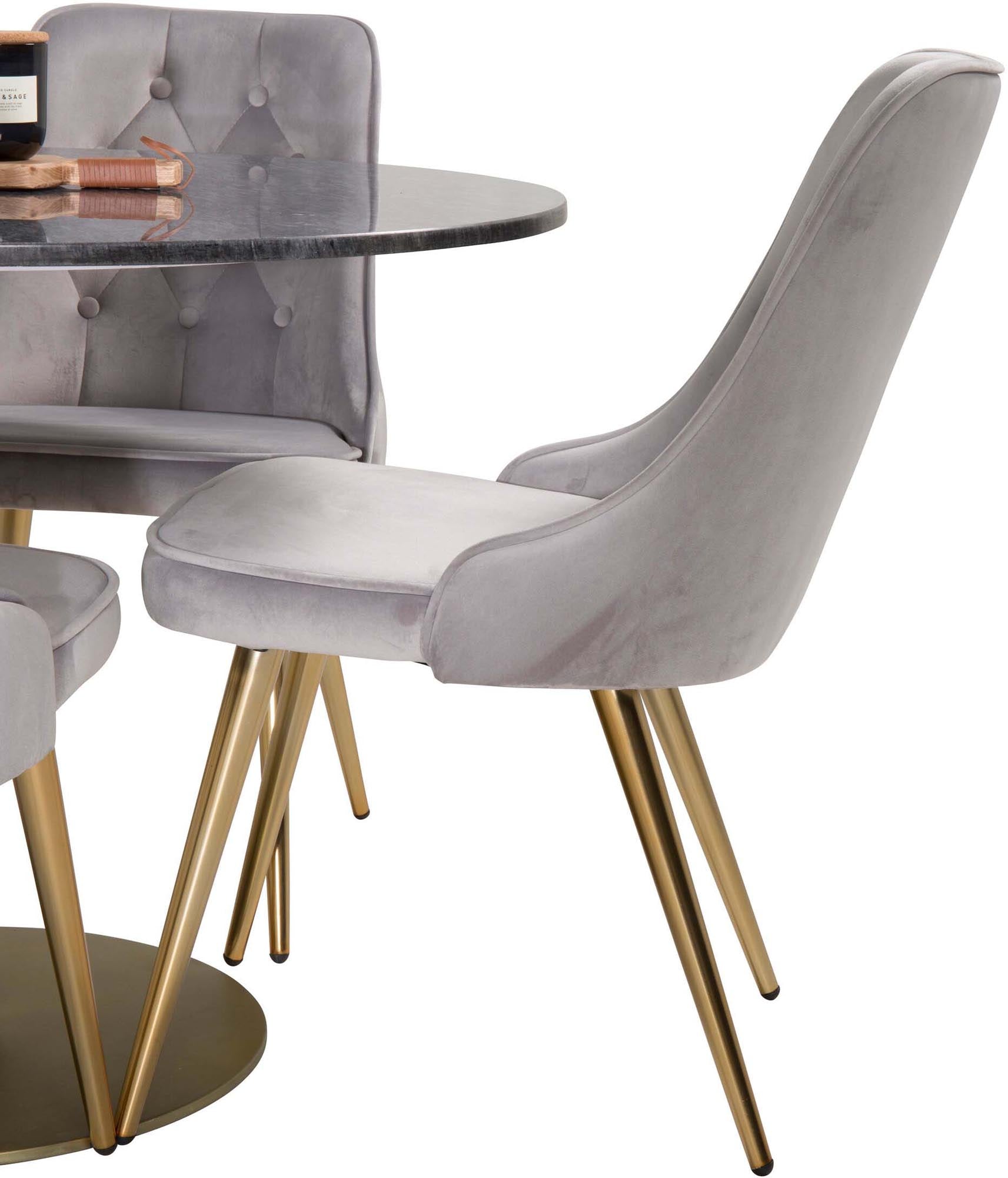 Elegantes Esszimmerset mit rundem Tisch und vier Samtstühlen.