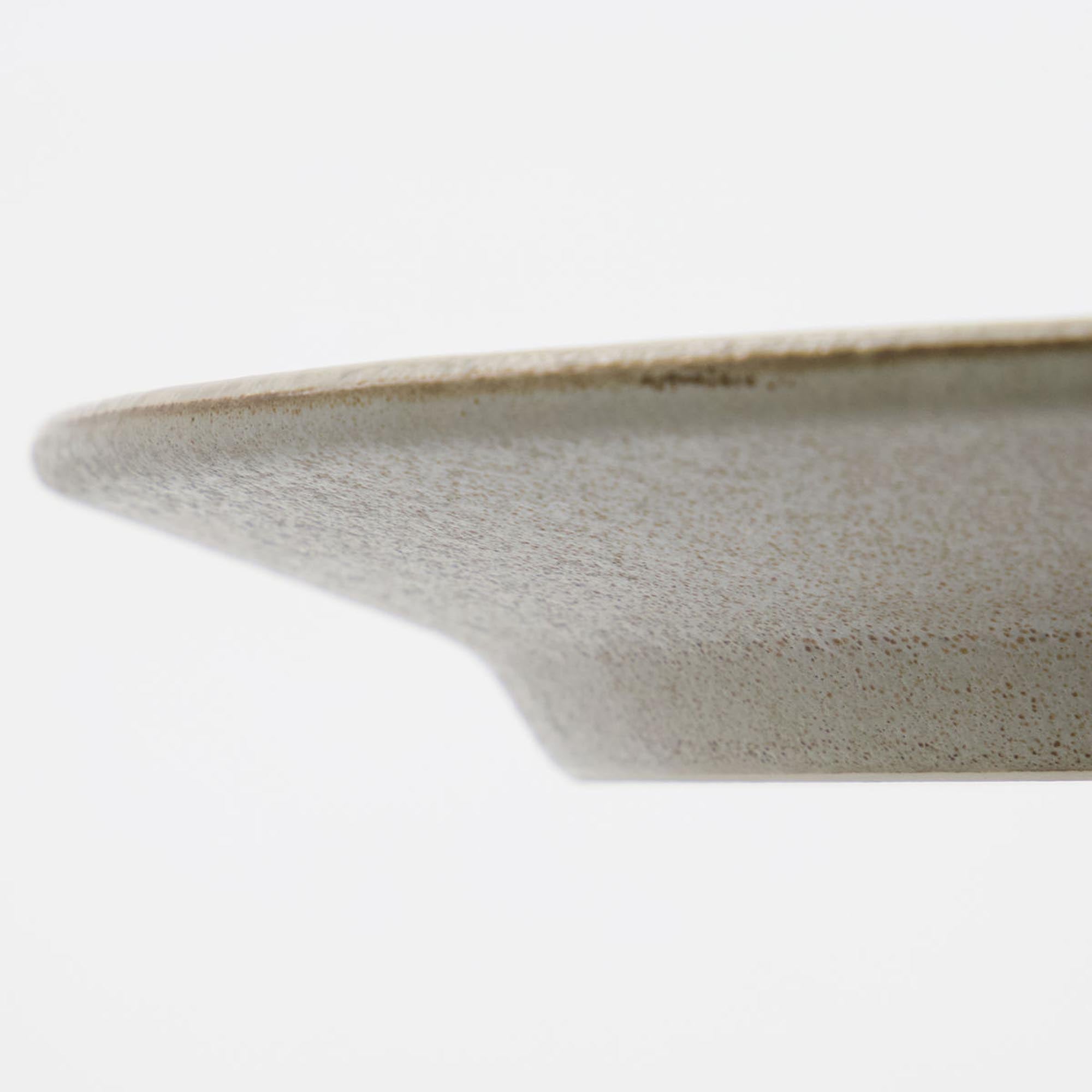 Eleganter HDPleat Teller von House Doctor in Grau/Braun, gefaltet.