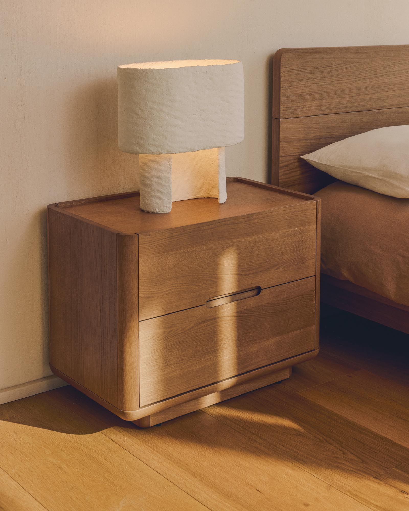 Moderne Tischlampe Bedala aus leichtem Pappmaché in Weiß, perfekt für eine gemütliche Atmosphäre in Wohn- und Schlafzimmer.
