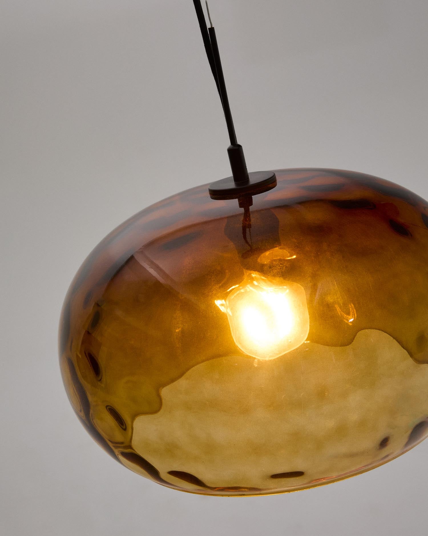 Die Balma Deckenleuchte von Kave Home kombiniert elegantes Klarglas mit warmen Holzelementen und sorgt für eine harmonische Lichtatmosphäre.