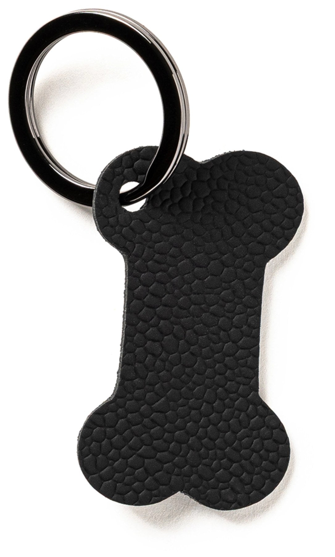 Schwarzer Schlüsselanhänger in Form eines Hundeknochens, flach und kompakt, Modell von MiLLE W NORDISK DESIGN.