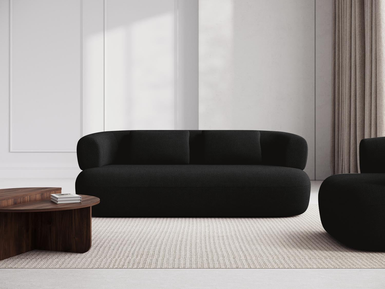Elegantes Jenny Boucle Sofa in stilvollem Schwarz, ideal für moderne Wohnräume. Komfortabel und zeitlos, perfekt für entspannte Abende.