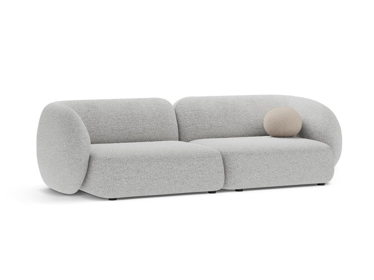 Weisses 4er Sofa Kate von Micadoni mit strukturiertem Bouclé-Stoff, schwarzen Kunststoffbeinen und breiter Sitzfläche.