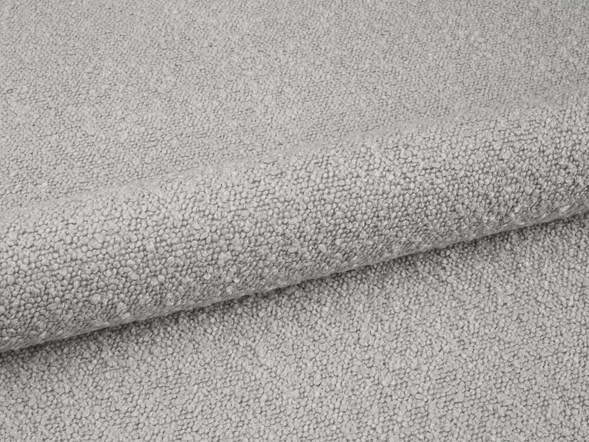Weisse Sitzbank Dia von Micadoni mit gepolstertem Bouclé-Bezug, schwarzen Kunststoffbeinen und kompaktem, rechteckigem Design.