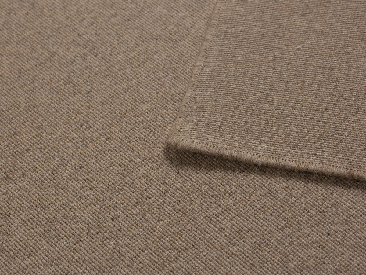 Dunkelbeiger Terra Teppich aus 100% Wolle von Micadoni, rechteckige Form, Grösse 230 x 160 cm, flacher Flor mit sauber verarbeiteten Kanten.