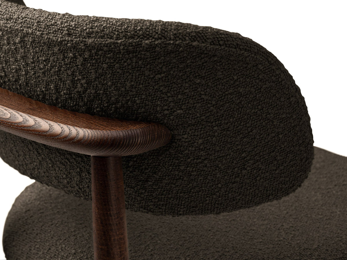 Beige gepolsterter Stuhl mit dick strukturiertem Bouclé-Stoff, gerader Rückenlehne und vier Beinen aus Nussbaumholz, Frontalansicht.