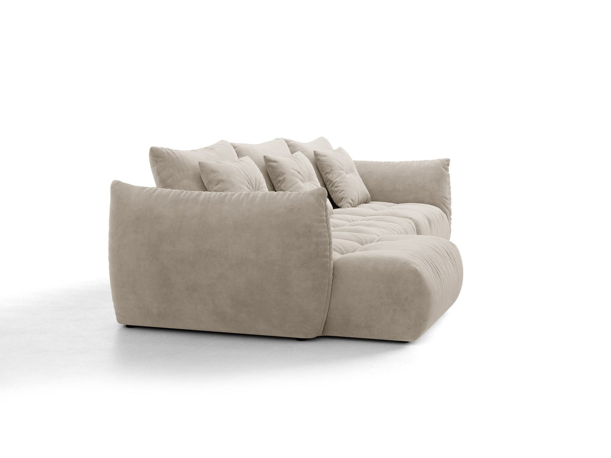 Beiges L-Sofa links von Micadoni mit weichem Veloursstoff Casino, schwarzen Kunststoffbeinen und breiter, tiefer Sitzfläche.