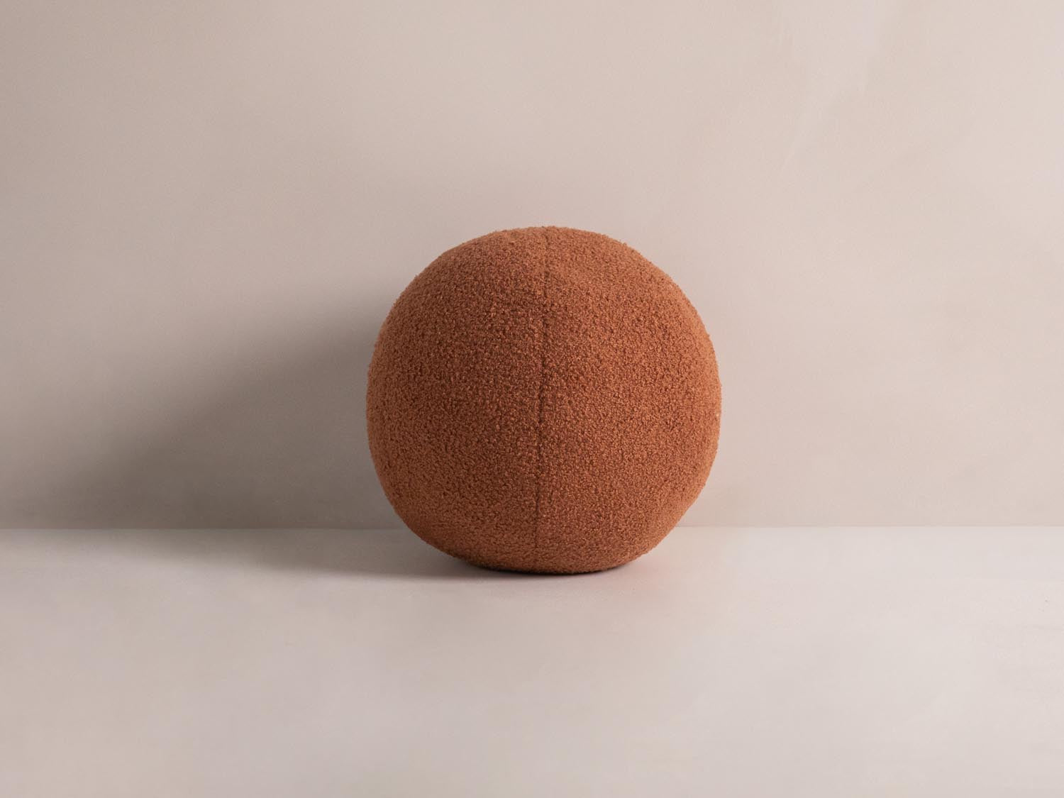 Rundes Ball Pillow in warmem Ziegelrot von Micadoni, ideal als stilvolles Deko Kissen für jedes Wohnambiente.