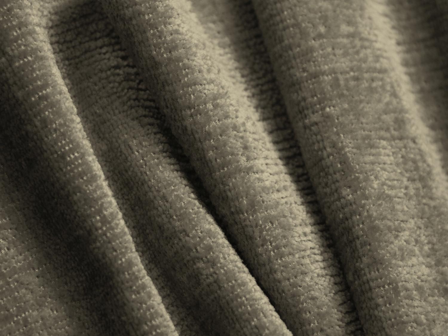 Modernes L-Sofa Jenny in ansprechendem Grün, ideal für große Räume und gesellige Zusammenkünfte, vereint Komfort und zeitgemäßes Design.