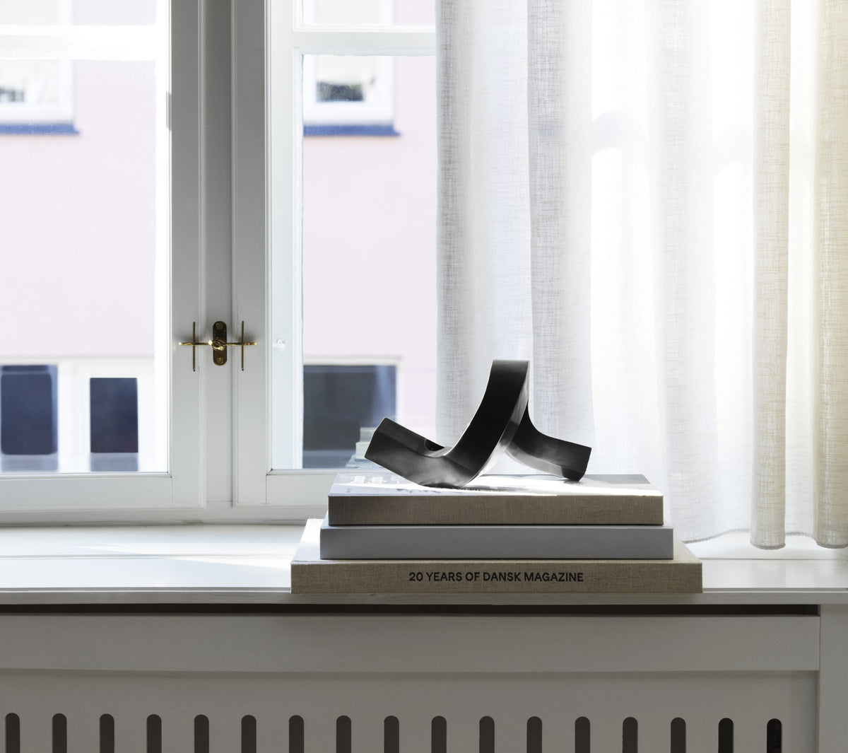 Kerzenhalter Crooked von Normann Copenhagen aus lackiertem Aluminium in Warmes Grau mit geschwungener, skulpturaler Form.