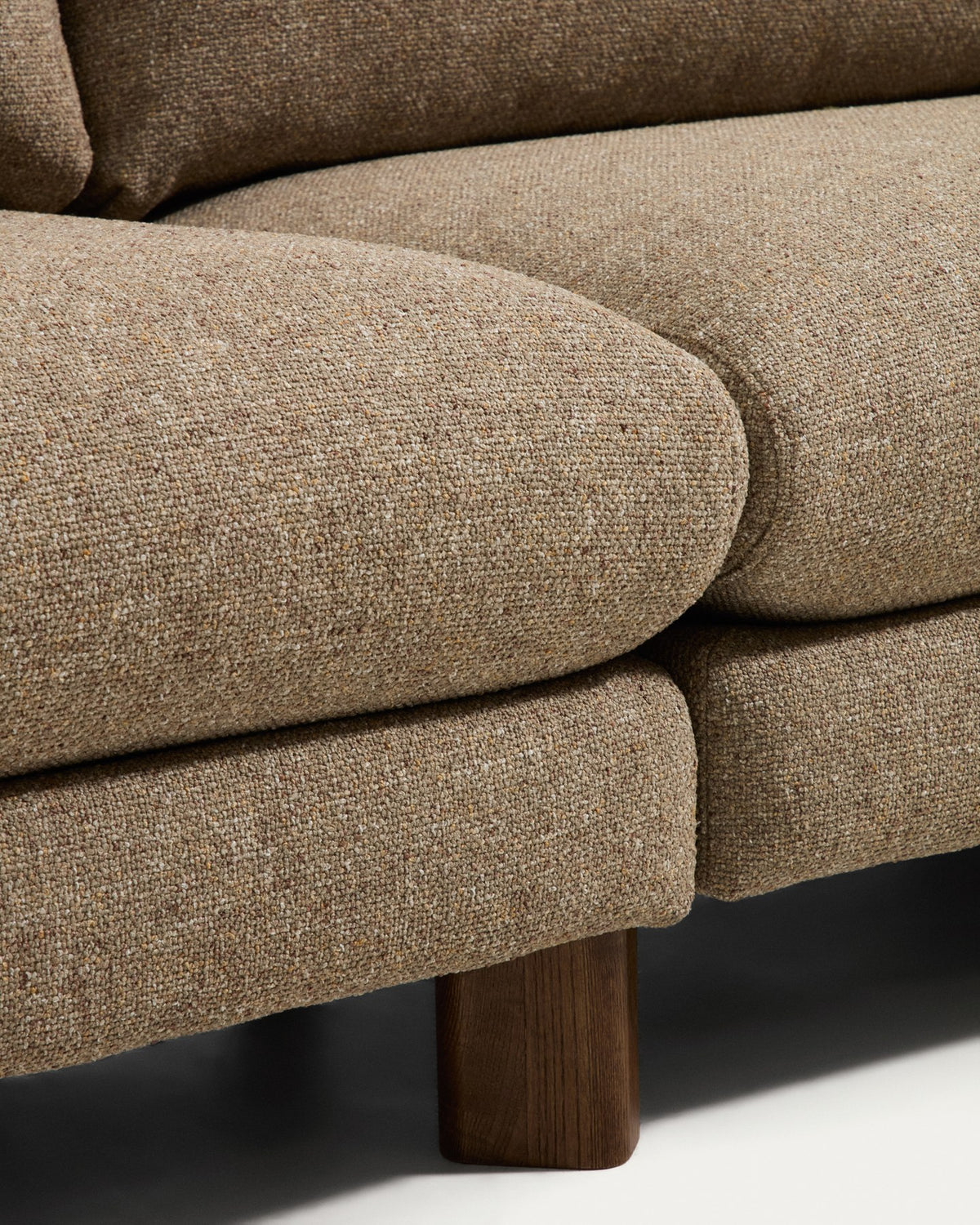 4-Sitzer Sofa Vera in Hellbraun mit gepolsterten Armlehnen und sichtbaren Beinen aus massivem Eschenholz mit Nussbaum-Finish.