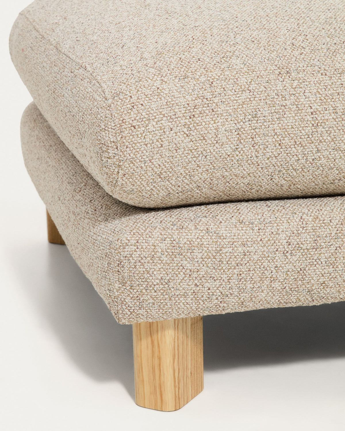 Quadratische Fussablage in Beige mit strukturiertem Gewebebezug und sichtbaren Beinen aus massivem Eschenholz mit natürlichem Finish.