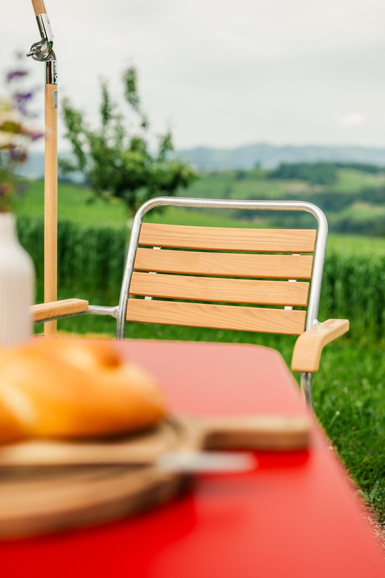 Rigi Holzlatten-Gartenstuhl mit Armlehne in Natur geölt präsentiert im Onlineshop von KAQTU Design AG. Gartenstuhl mit Armlehnen ist von Schaffner