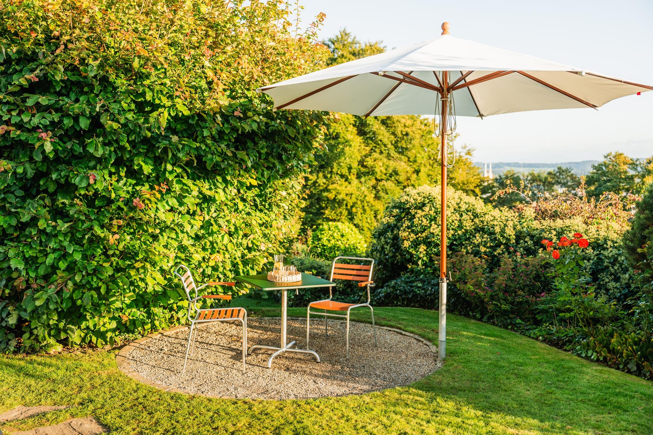 Säntis Lättli-Gartenstuhl mit Armlehne in Pastellterracotta präsentiert im Onlineshop von KAQTU Design AG. Gartenstuhl mit Armlehnen ist von Schaffner