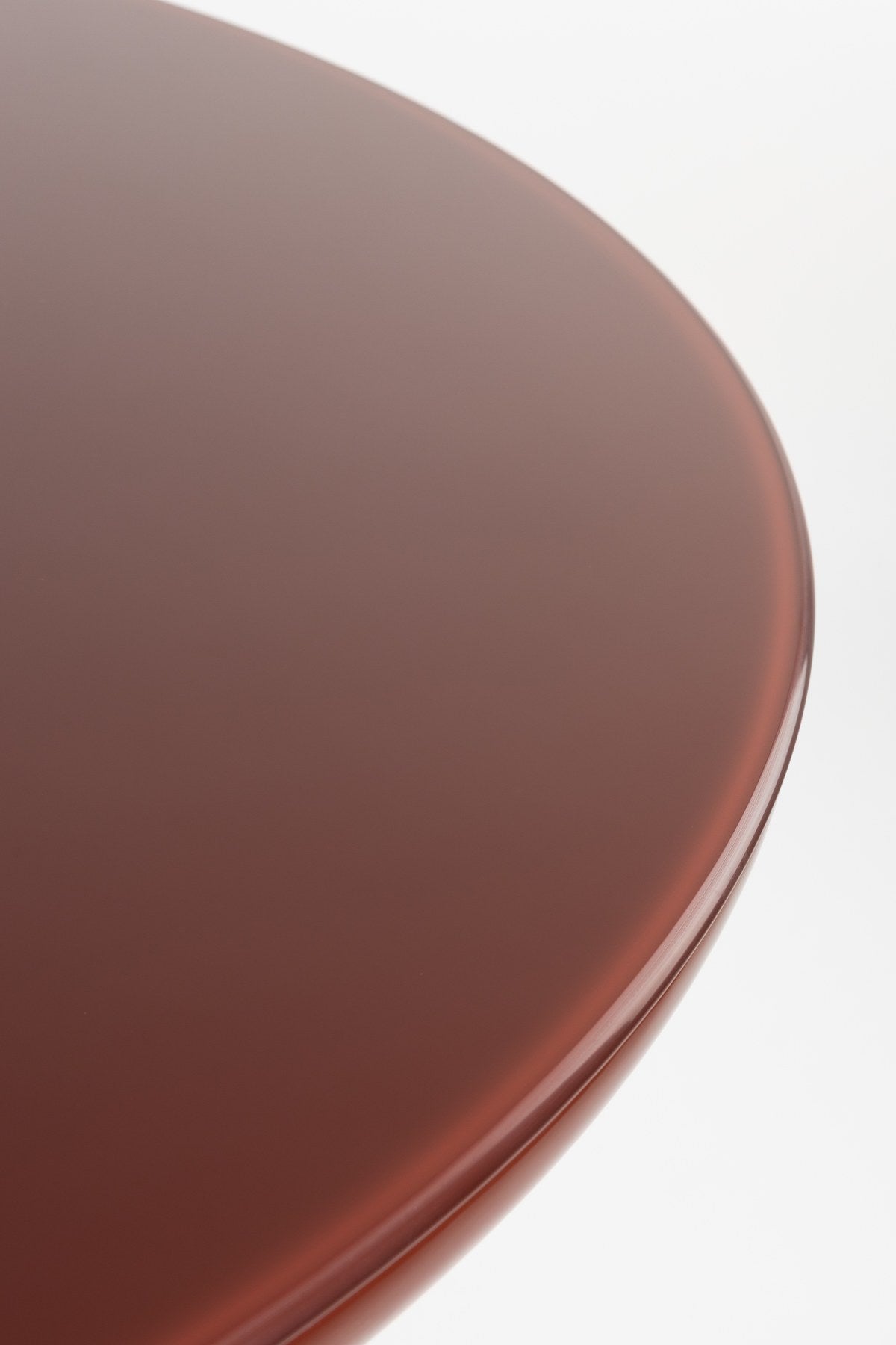 Runder Esstisch Dining Table Timo mit roter Hochglanz-Tischplatte und schwarzem Gestell aus Eisen mit vier gerillten Beinen in der Mitte.