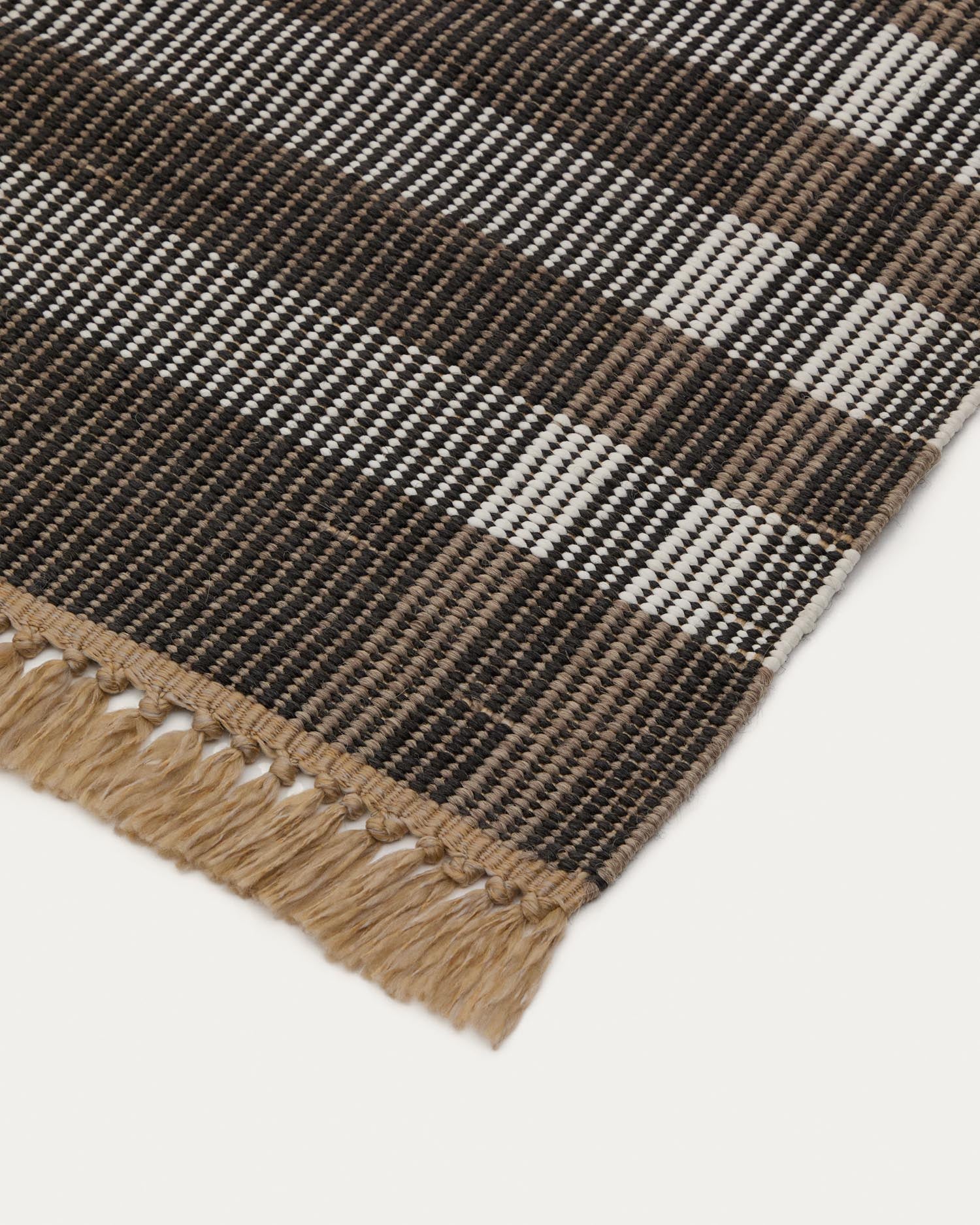 Entdecken Sie den stilvollen Teppich Barani (60 x 90 cm) von Kave Home – ein handgefertigtes Designstück aus langlebigen Synthetikfasern in edlem Braun und Schwarz.