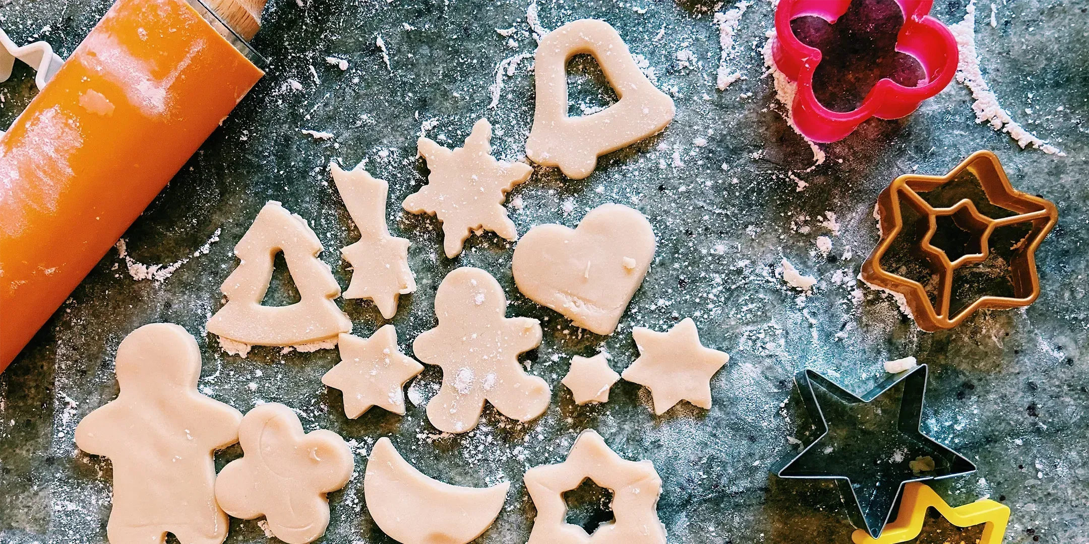 Ausstechformen in verschiedenen kreativen Designs, perfekt für Plätzchen und besondere Anlässe, präsentiert auf einer rustikalen Holzoberfläche.