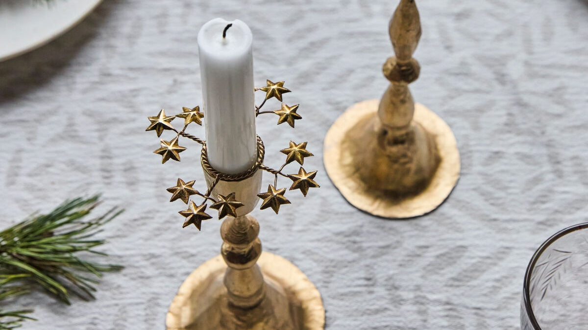 Goldener Kerzenring als Adventsschmuck mit brennenden Kerzen