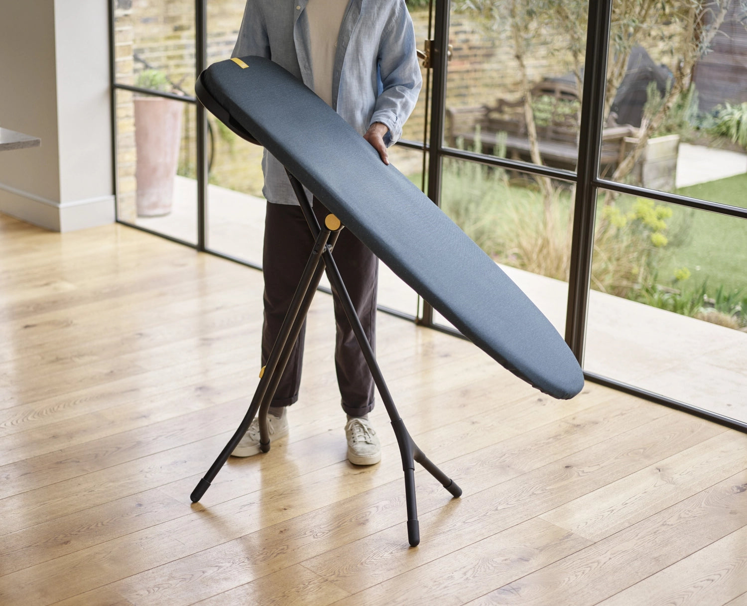 Elegantes Glide Max Plus Bügelbrett in Schwarz und Blau von Joseph Joseph, ideal für müheloses Bügeln und einfach zu verstauen.