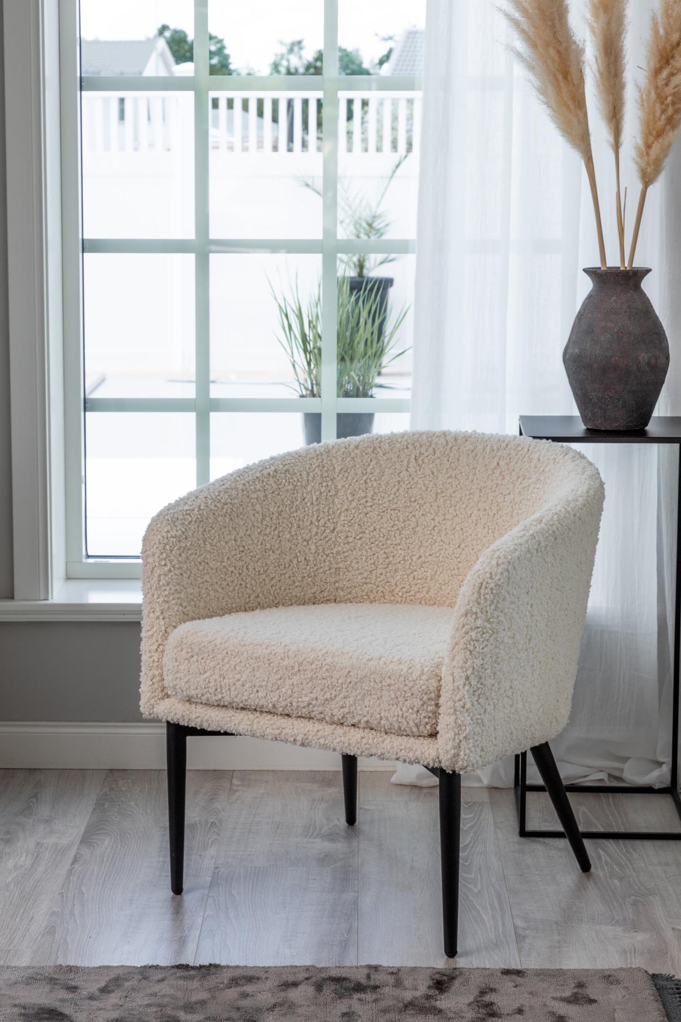 Der Fluffy Sessel von Venture Home: Kuscheliges Teddy-Material trifft auf modernes Design mit schwarzem Metallgestell.