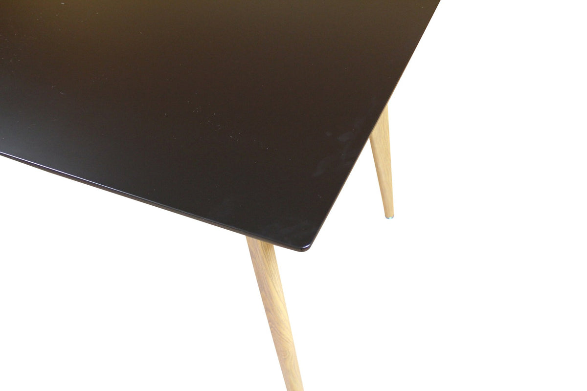 Rechteckiger Esstisch Polar von Venture Home mit schwarzer MDF-Tischplatte und naturfarbenen, leicht ausgestellten Metallbeinen im skandinavischen Design.