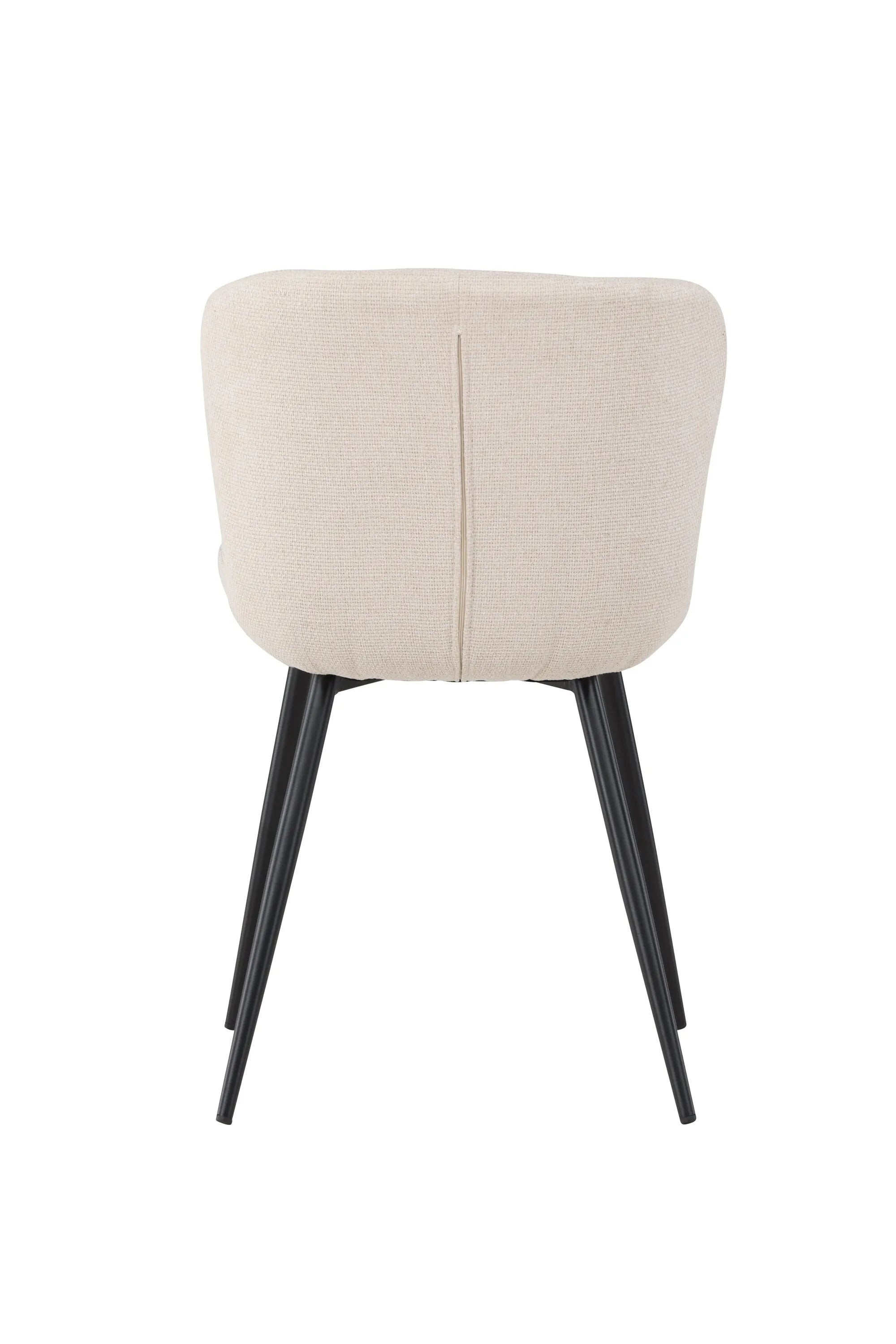 Der Lily Esszimmerstuhl vereint elegantes Design mit Komfort: Beige Polsterung, schwarze Beine, ideal für stilvolle Esszimmer.