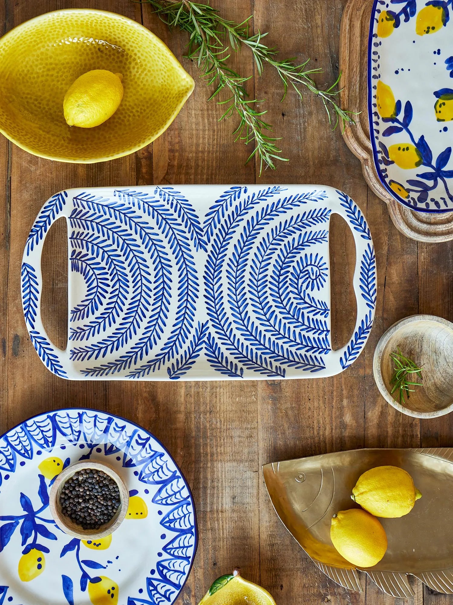 Elegantes blaues Steingut-Tablett mit handdekoriertem Naturmuster, ideal für stilvolle Tischdekorationen.