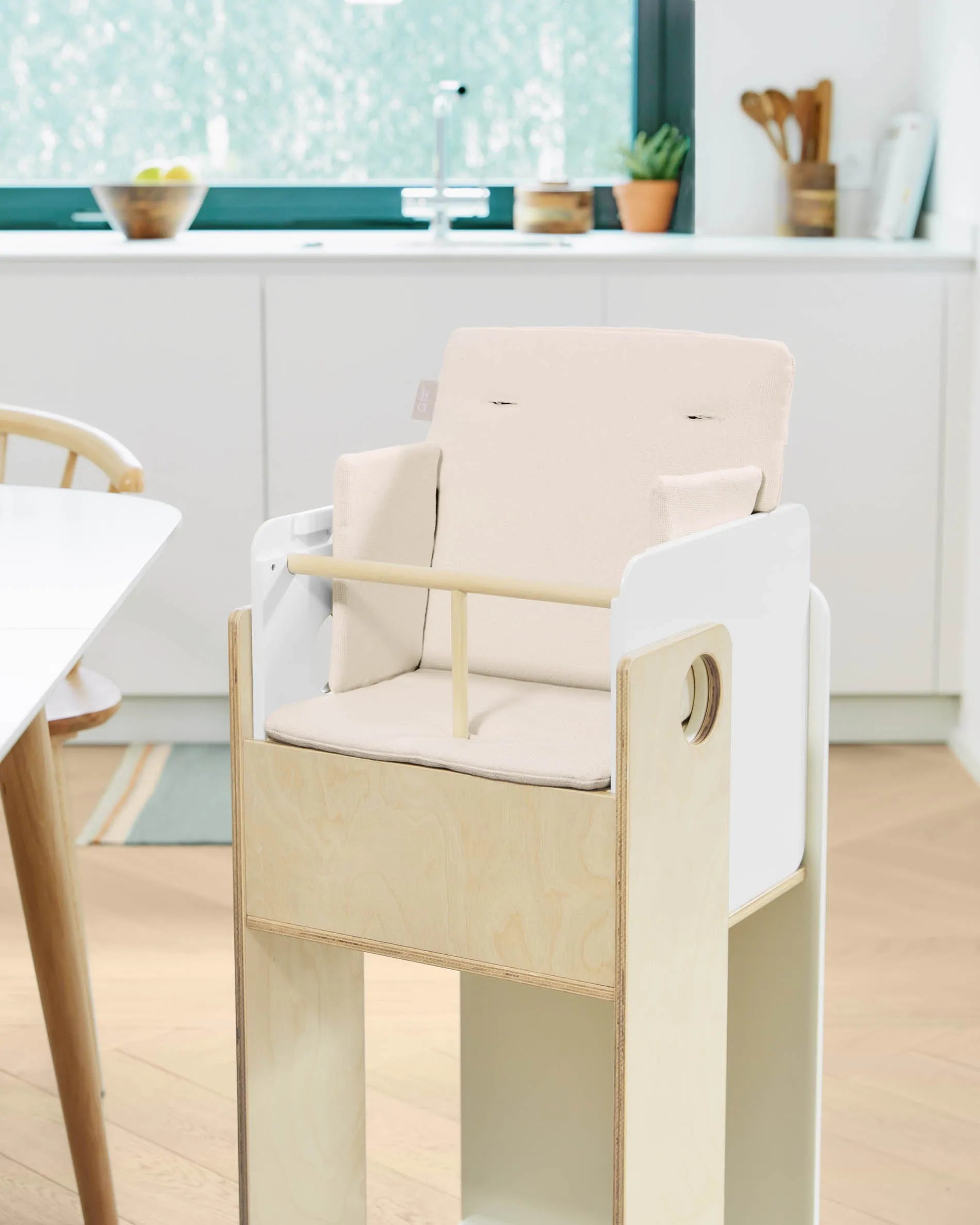 Das Nuun Hochstuhl Kissen von Kave Home bietet Komfort und Schutz aus 100% GOTS-zertifizierter Bio-Baumwolle in natürlichem Design.