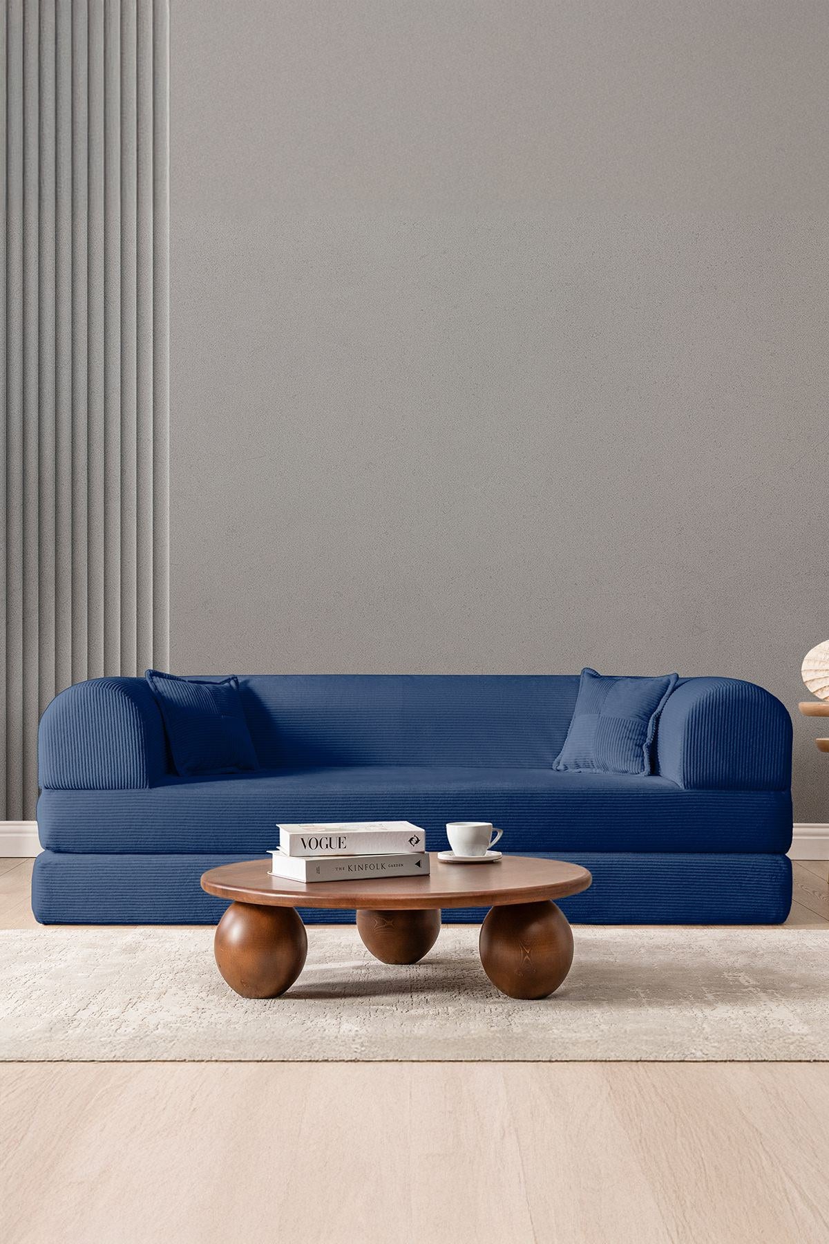 Marineblaues 3-Sitzer Schlafsofa Legom Eco von Hanah Home aus geripptem Cord-Plüschstoff mit zwei Kissen und niedrigem Rückenteil.