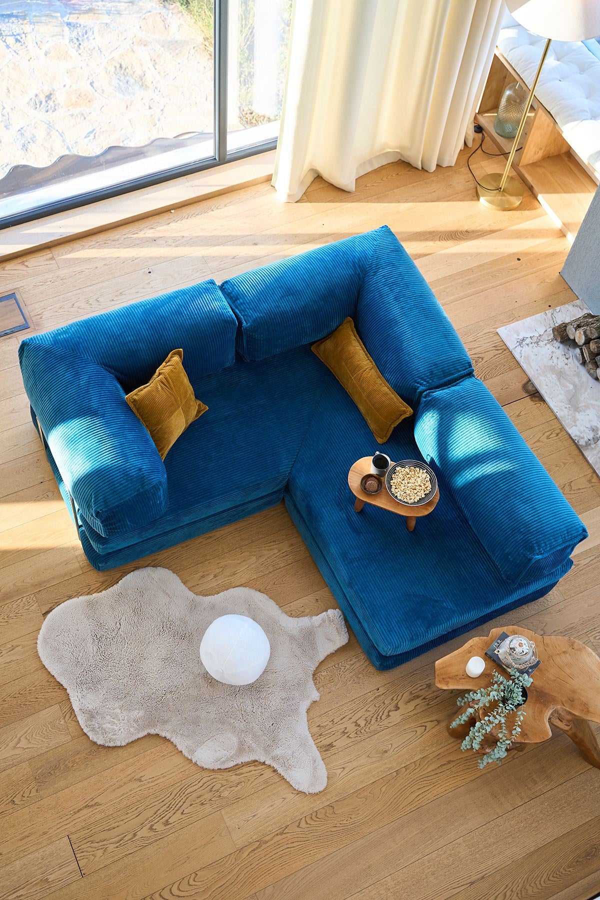 Kanyon Eck-Schlafsofa in Indigo von Hanah Home aus geripptem Cord-Plüschstoff, L-Form mit vier mitgelieferten Kissen.