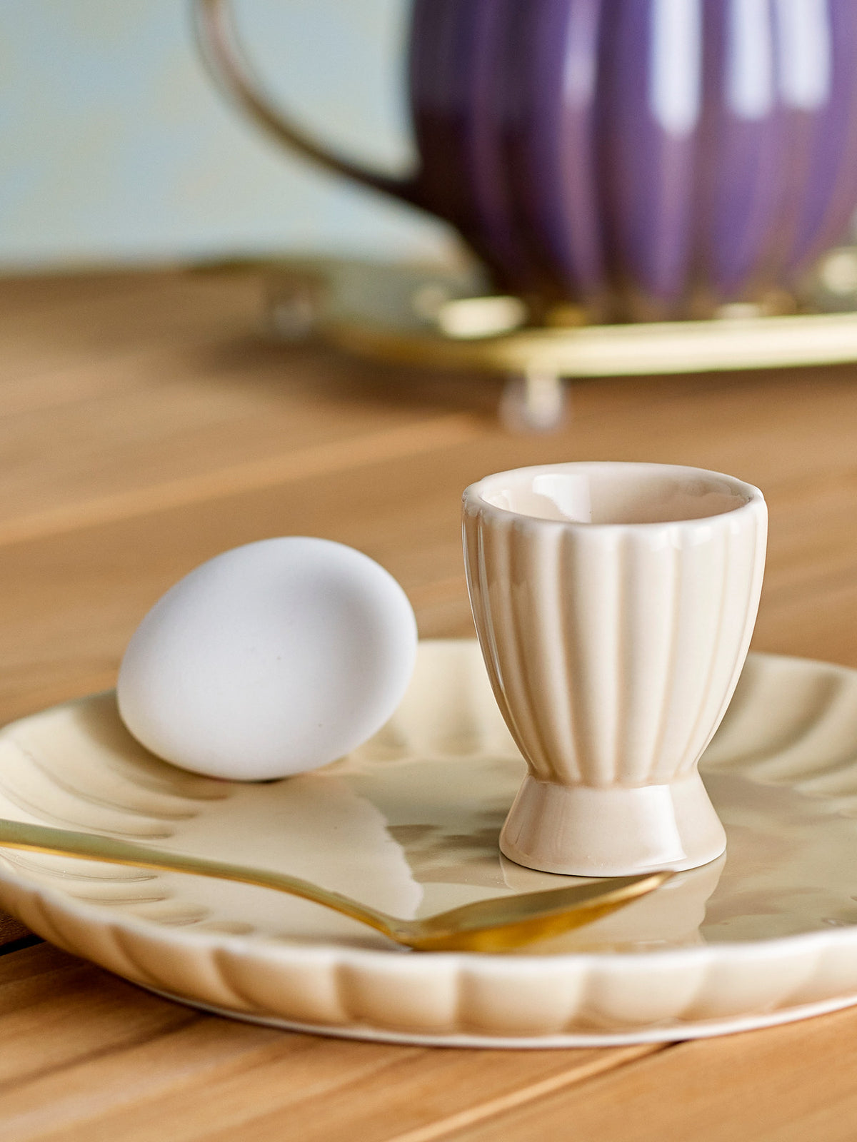 Beiger Eierbecher aus Steingut der Serie Latina von Bloomingville, rund geformt mit glänzender Glasur und leicht unregelmässiger Oberfläche.