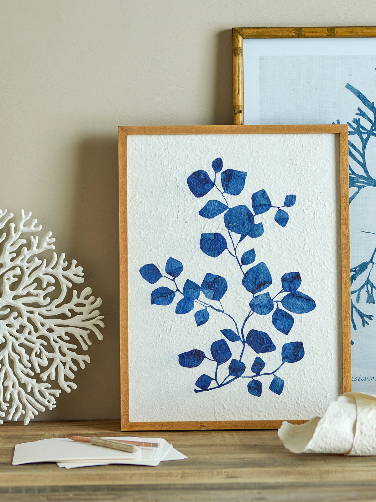 Wanddekoration Gunnvor in Weiss aus Tannenholz, MDF und Papier mit blauem botanischem Zweigmotiv und leicht strukturierter Oberfläche.
