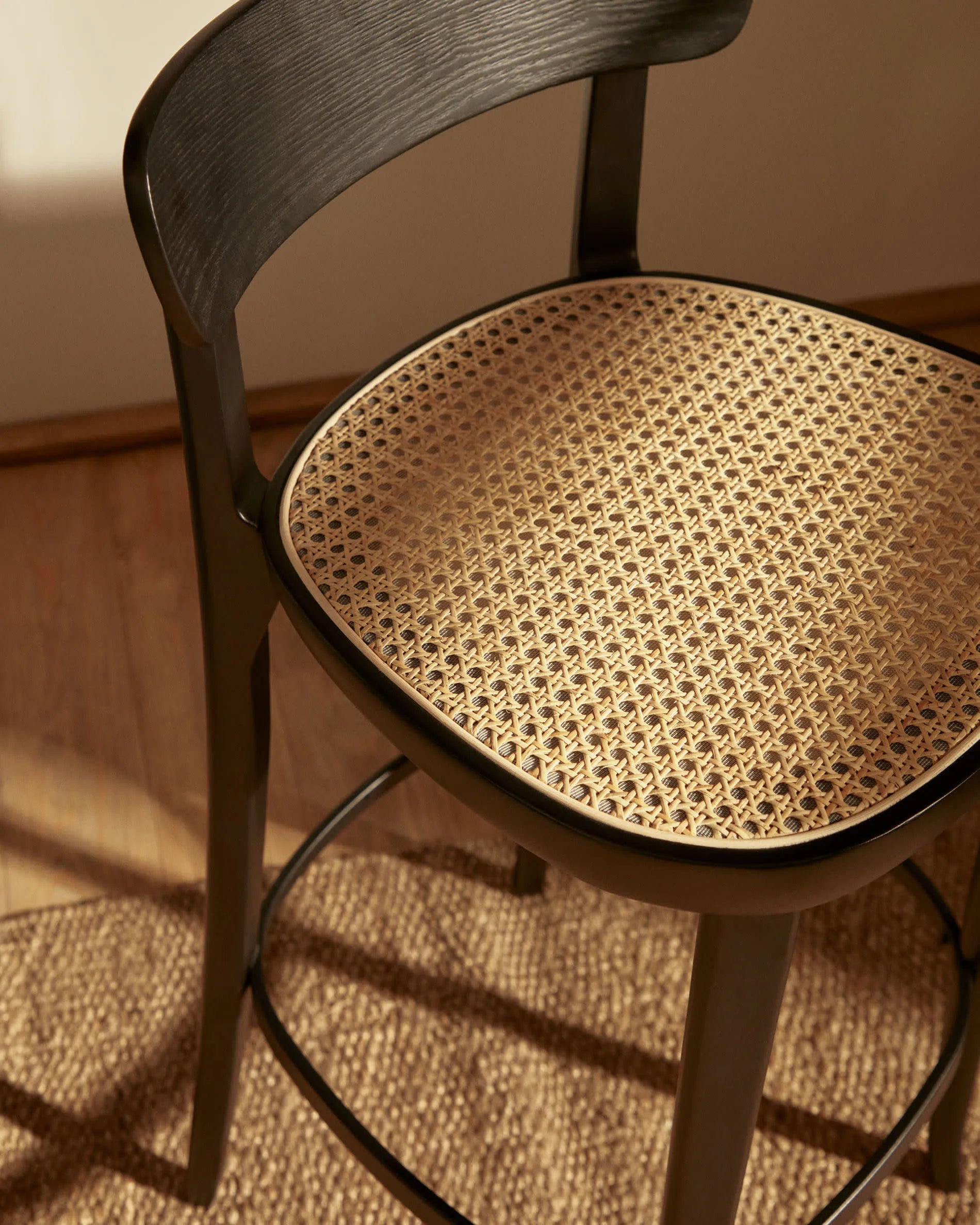 Eleganter Hocker aus Buchenholz mit schwarzem Finish, Eschenfurnier und Rattansitz, ideal für moderne Wohnräume, 75 cm hoch.