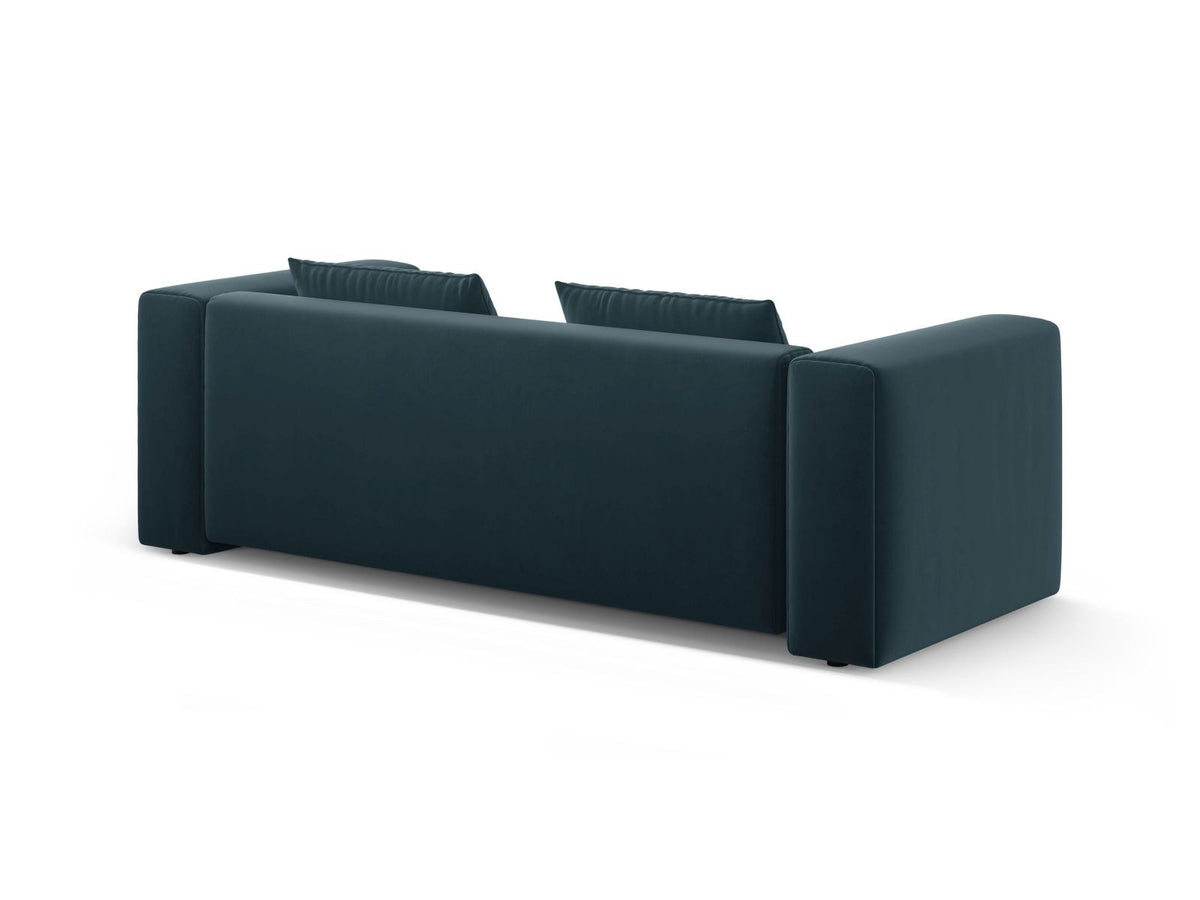 Sandfarbenes Samt-Bettsofa Verona mit drei Sitzplätzen, ausklappbarer Liegefläche, Bettkasten und schwarzen Kunststoffbeinen im Wohnraum.