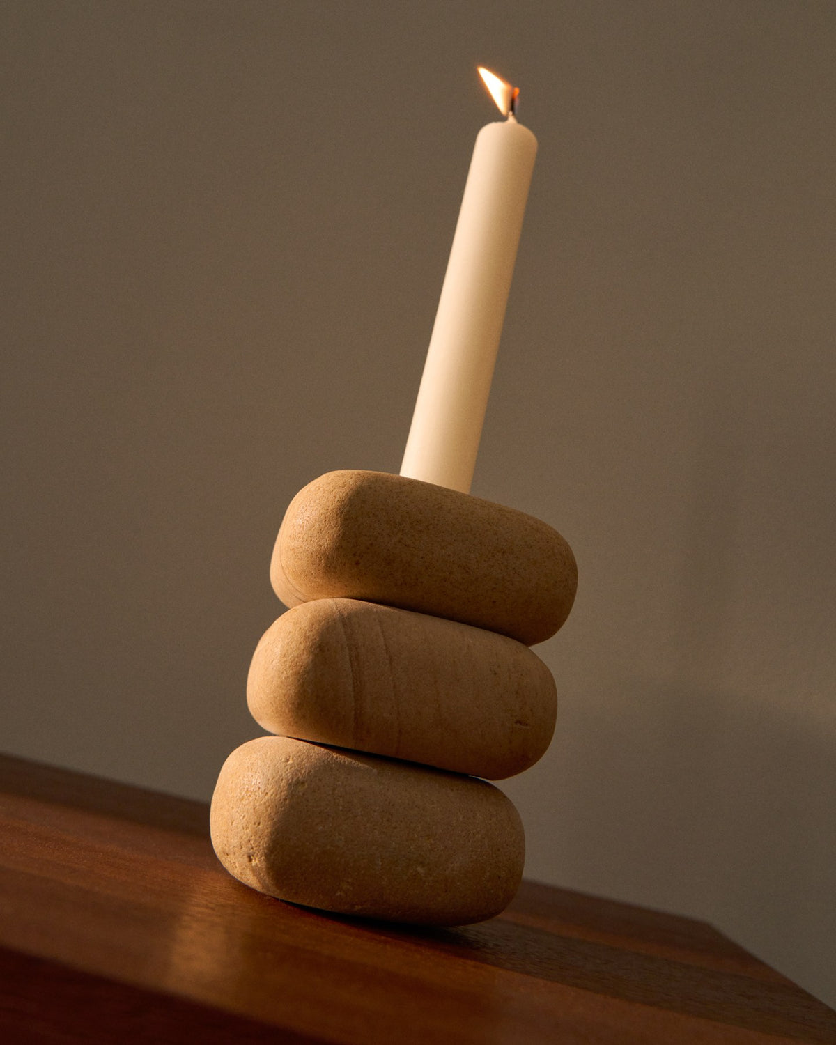 Kerzenständer Liren aus beigem Sandstein, handgefertigt, quadratische Grundform, Höhe 11 cm, Naturstein mit individueller Maserung.