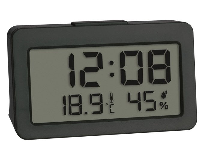 Digitaler TFA Mini-Wecker in Anthrazit mit Display für Uhrzeit, Innentemperatur und Luftfeuchtigkeit in kompakter, rechteckiger Bauform.