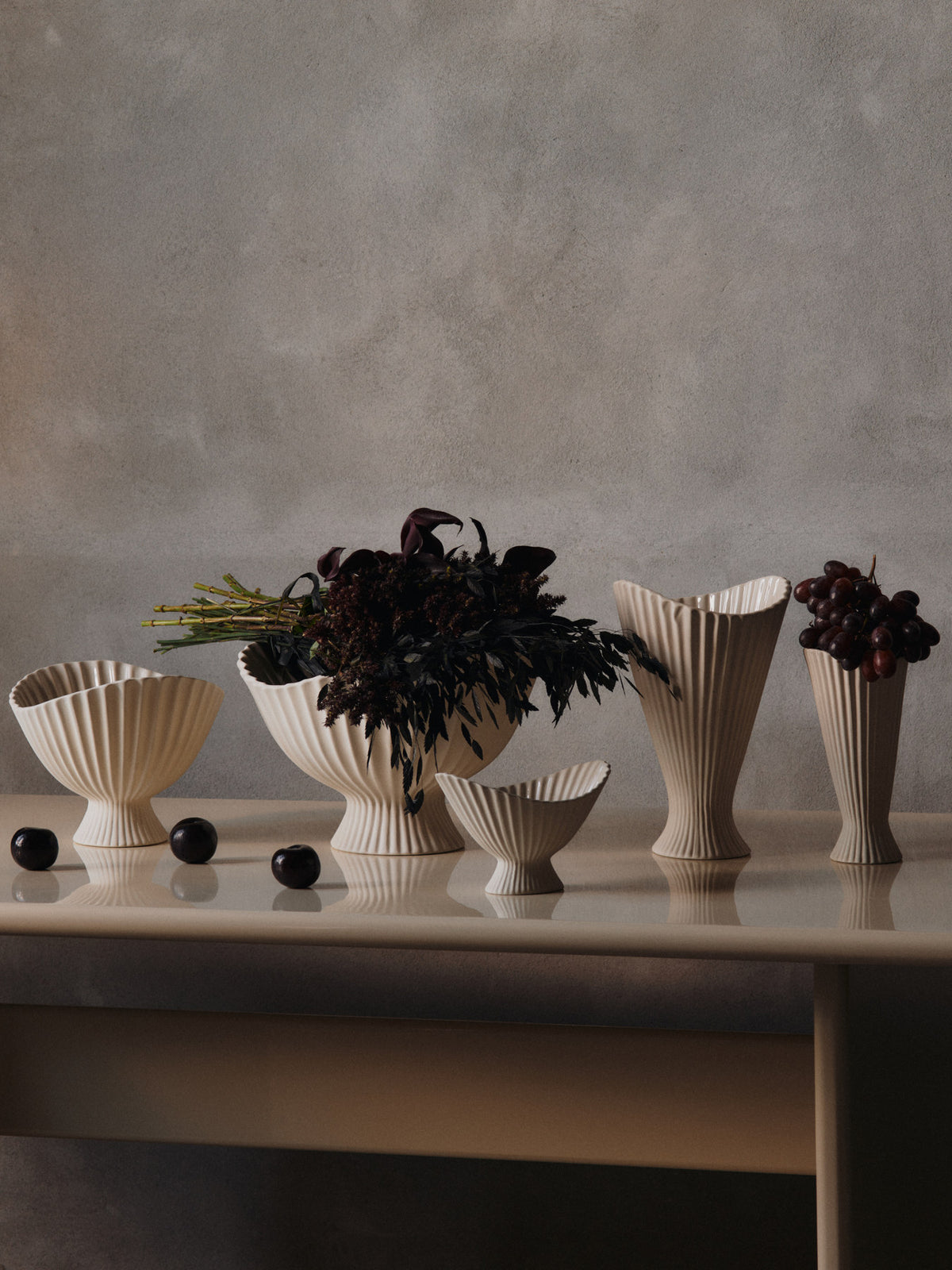 Fountain Vase von Ferm Living aus Steingut in Off-White, aussen matt und unglasiert, innen glasiert, mit gefältelter, geschwungener Form.