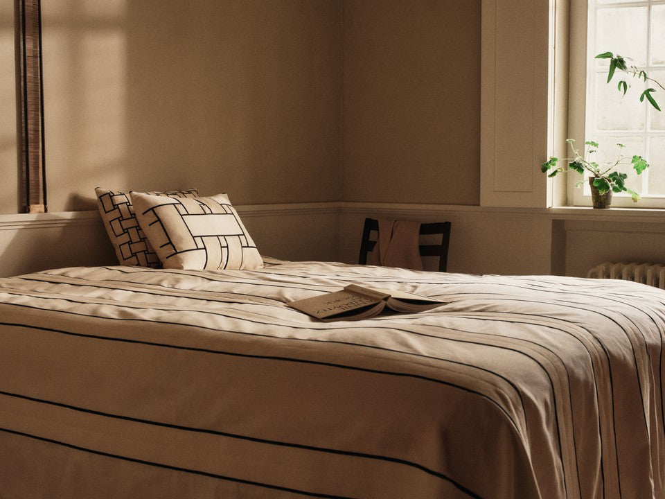 Rechteckiges Lattice Offset Kissen von Ferm Living in Off-white und Schwarz, stilvolles Deko-Element für moderne Wohnräume.