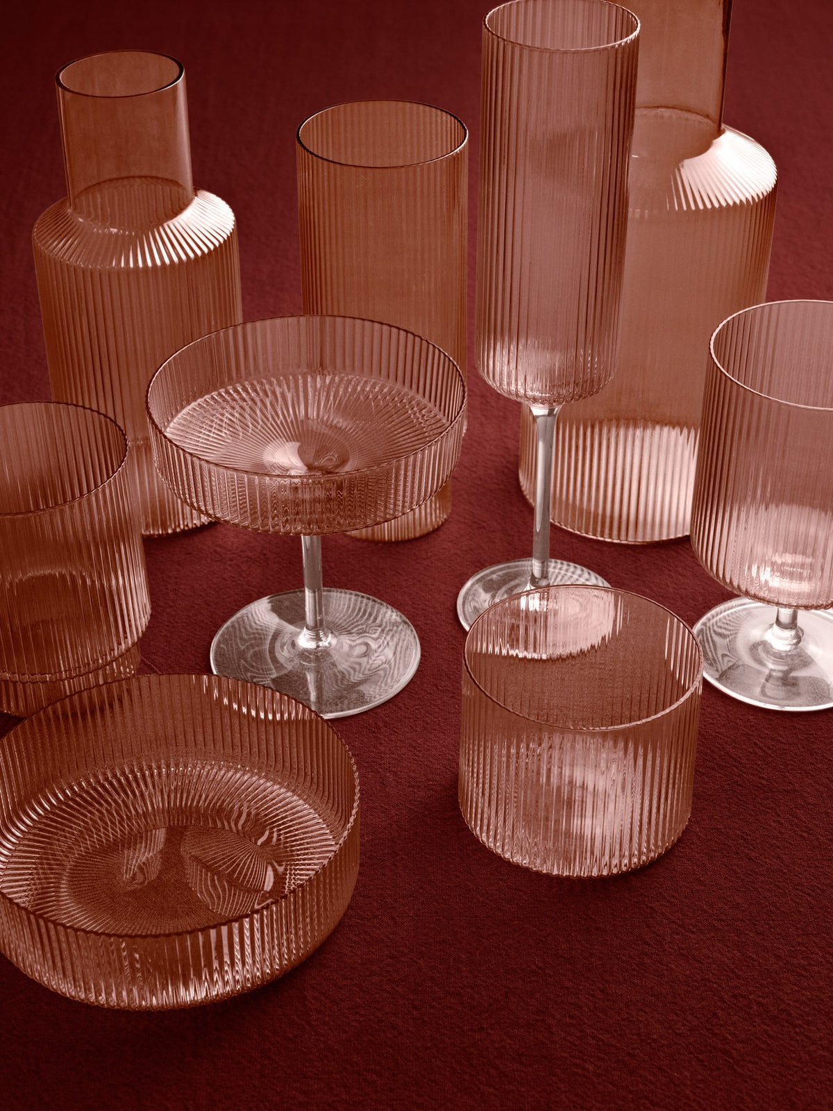 Vier Servierschüsseln aus mundgeblasenem Glas mit geriffelter Oberfläche, Farbe Blush, runde geometrische Form.
