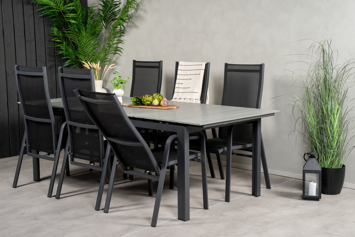 Rechteckiger Gartentisch mit grauer Aintwood-Platte und Aluminiumgestell, daneben zwei stapelbare Copacabana-Relaxsessel in Schwarz.