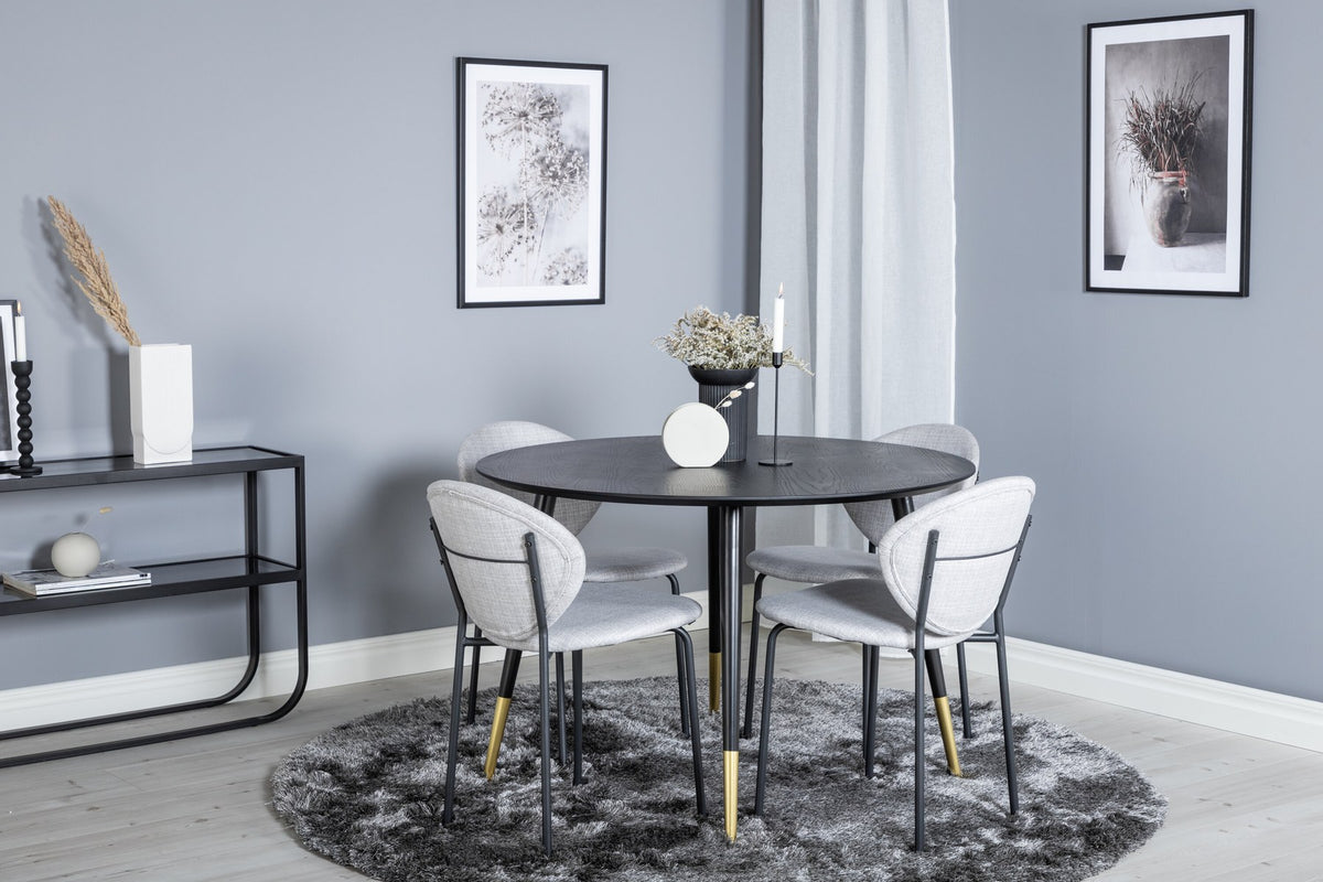Schwarzes Esszimmerset Dipp mit Vault Stühlen: Tisch mit MDF-Furnierplatte und Stahlbeinen, Stühle mit Polsterbezug und Stahlgestell.