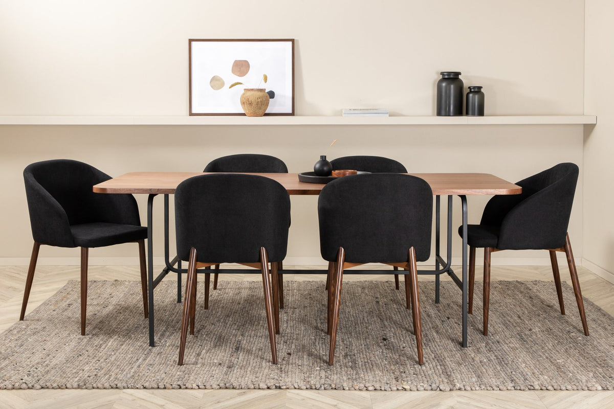 Esszimmerset Uno: rechteckiger Tisch mit MDF-Furnier-Platte in Nussbaum und schwarzem Stahlgestell, dazu Arch Stühle mit Polyesterbezug.