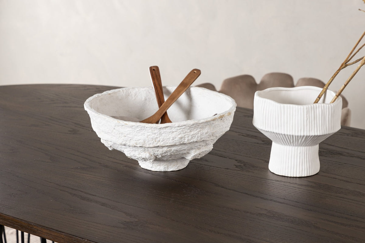 Ovaler Esstisch mit Tischplatte aus MDF mit Mocca-Furnier und schwarzem Metallgestell, umgeben von vier Limhamn-Stühlen mit beigem Samtbezug.