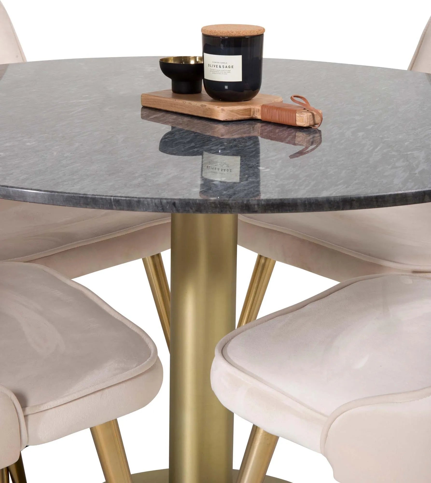 Elegantes Esszimmerset mit rundem Tisch und vier Samtstühlen.