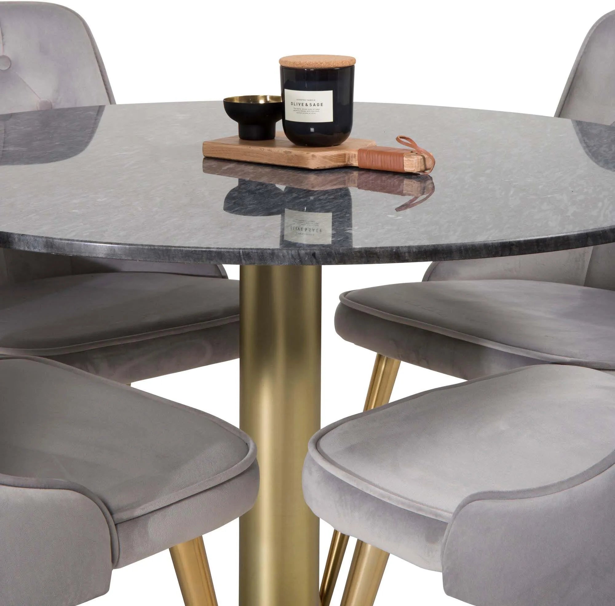 Stilvolles Esszimmerset mit rundem Tisch und vier edlen Samtstühlen.