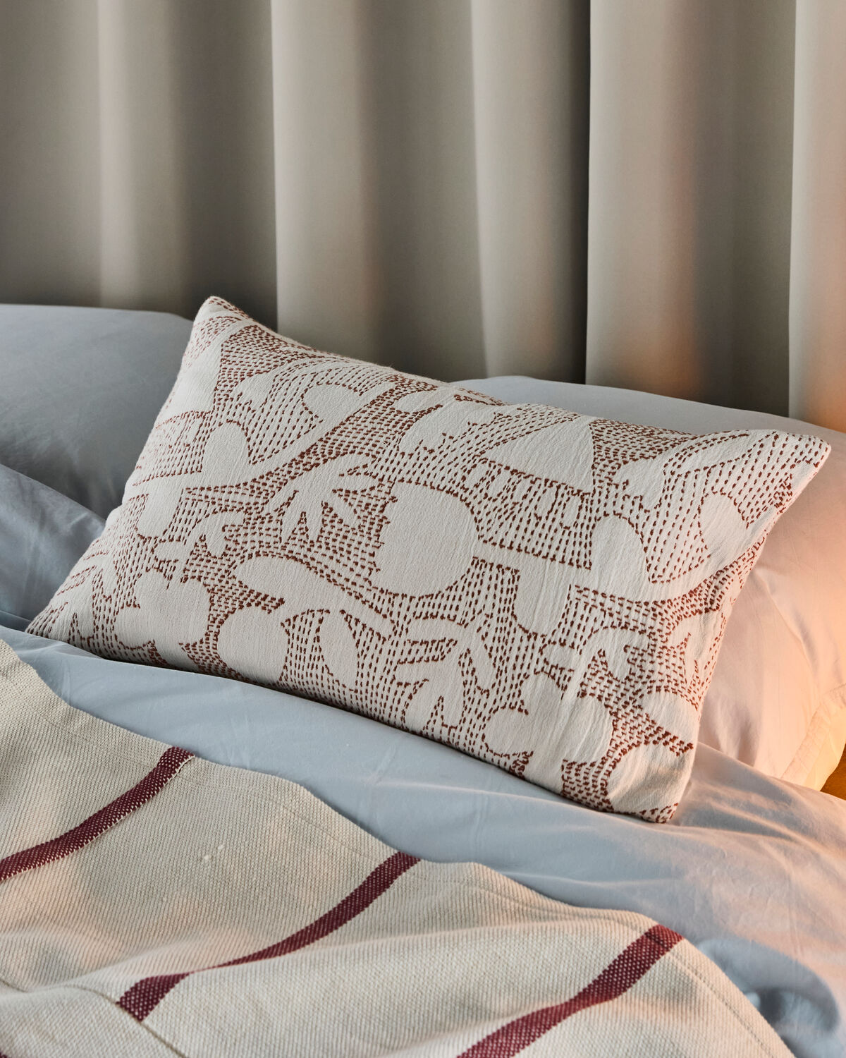 Stilvoller Kissenbezug HDSari in sanften Off-White- und Brauntönen, perfekt für eine gemütliche und moderne Einrichtung.