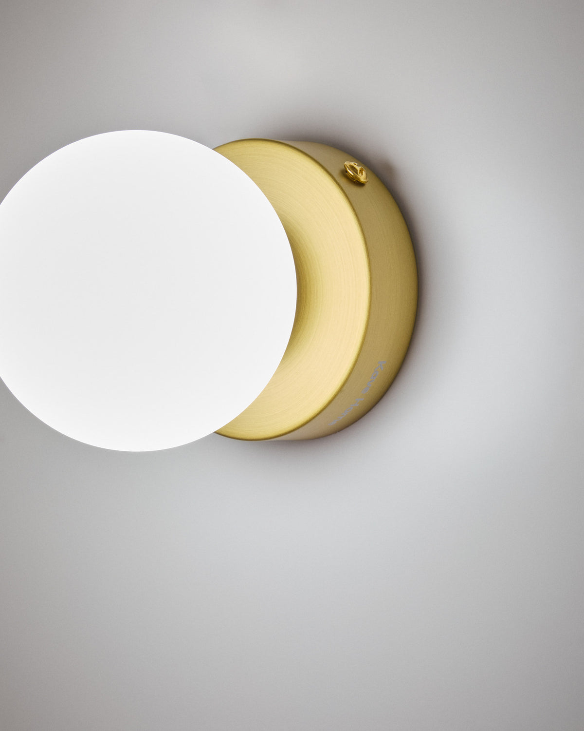 Wandleuchte Brisia aus Metall mit gebürstetem Messing-Finish und einer mattierten Glaskugel Ø 8 cm in Gold präsentiert im Onlineshop von KAQTU Design AG. Wandleuchte ist von Kave Home