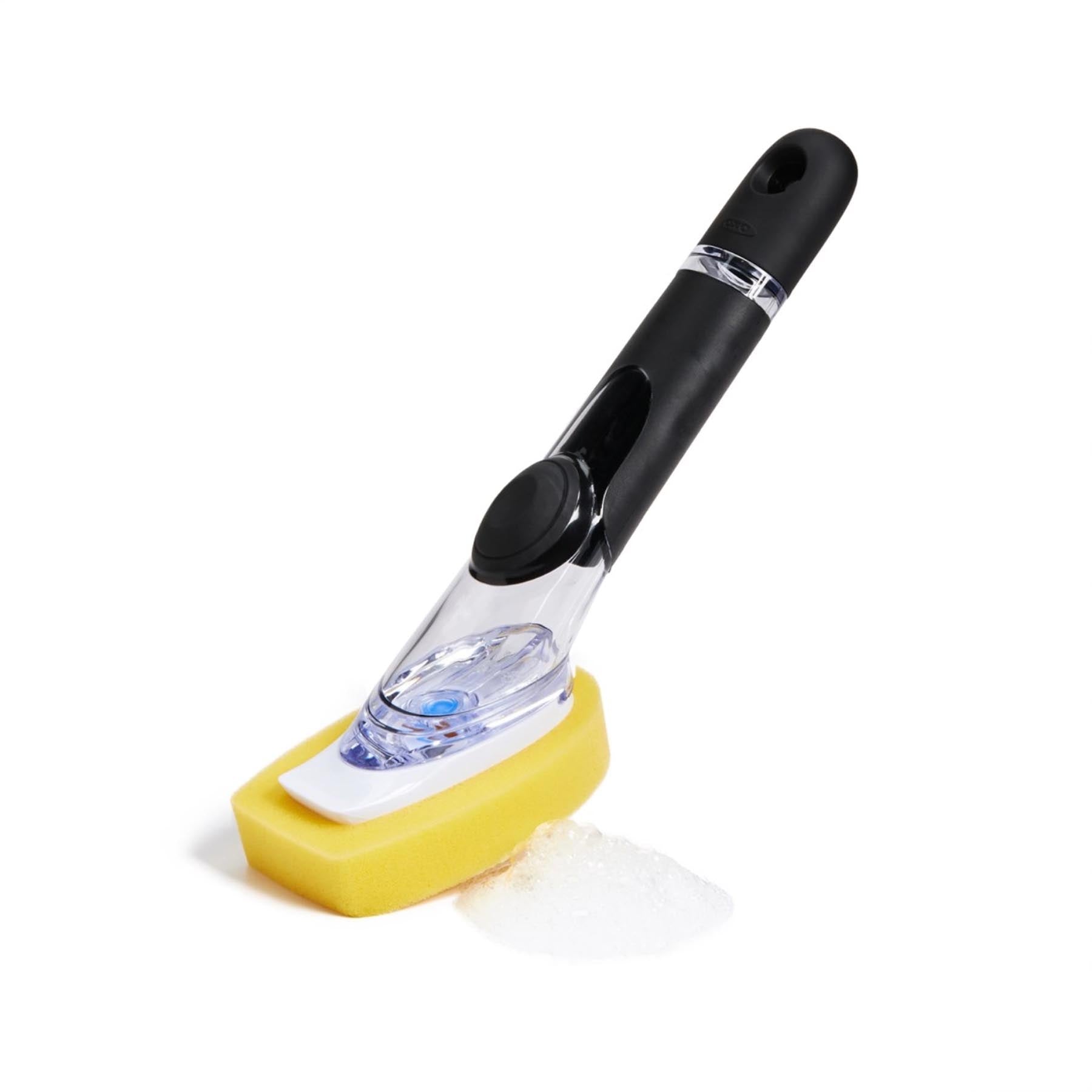 Praktischer GG Geschirrschwamm mit integriertem Seifenspender von OXO, ideal für effizientes Abwaschen in der Küche. In ansprechenden Farben.