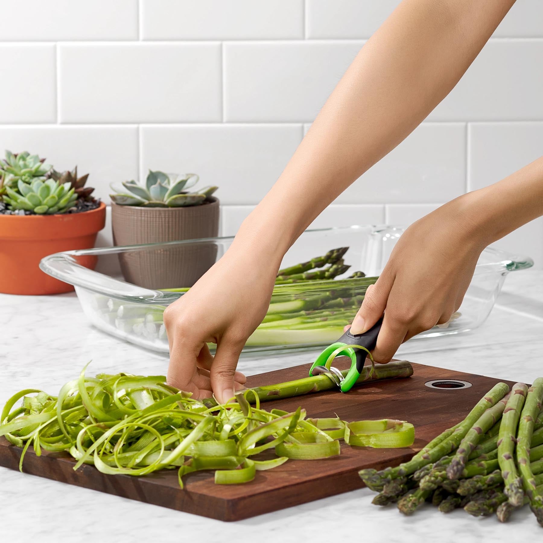Der OXO GG Spargel Schäler in frischem Grün, ideal zum mühelosen Schälen von Spargel und anderen Gemüsesorten.